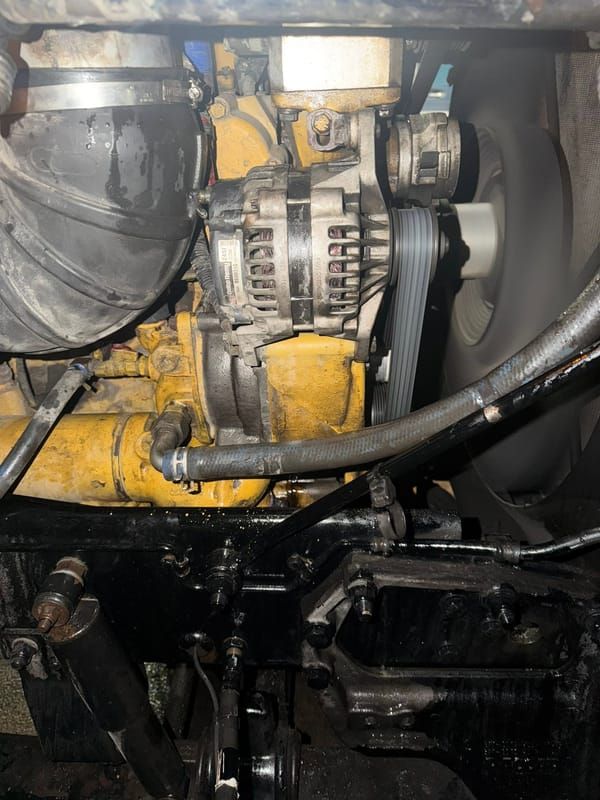Finished alternator installation on a Caterpillar diesel engine