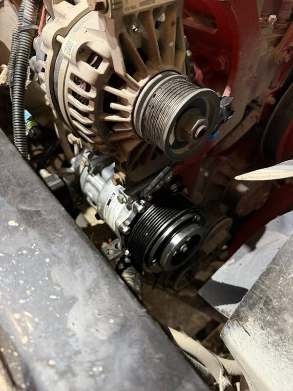 Alternator and AC compressor on a diesel engine during repair