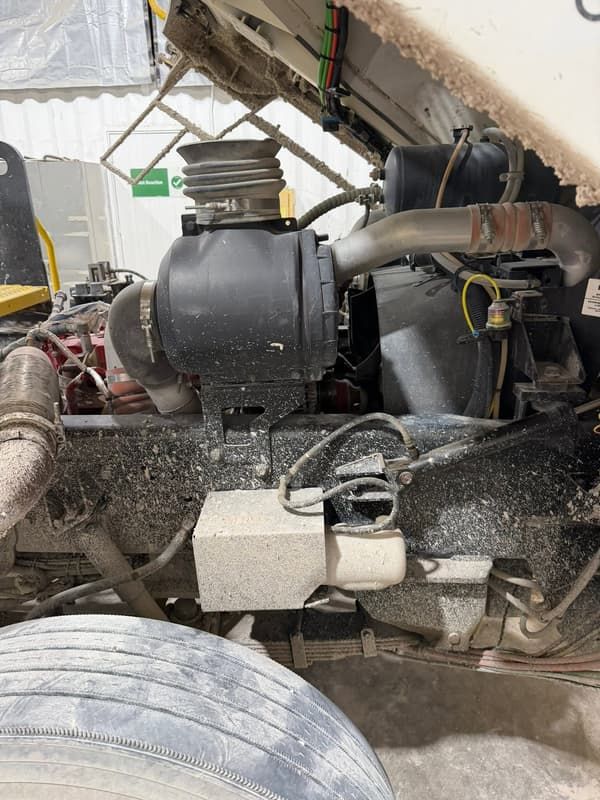 Truck engine bay with the air cleaner housing exposed during service