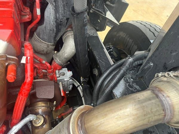 Diesel engine bay with turbo and exhaust piping during a repair